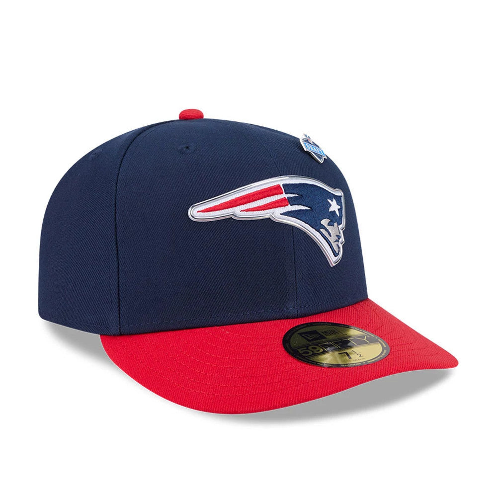 New England Patriots NFL Draft 2026 Dark Blue New Era 59FIFTY Fitted Cap, three-quarter view showing the raised Patriots logo embroidered on the front panel, with a red flat visor and gold 59FIFTY size sticker on top.