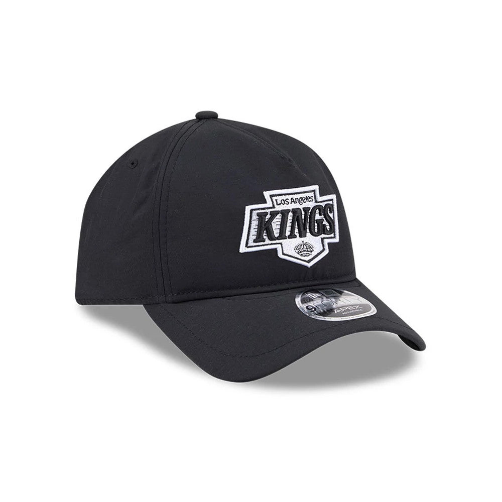 Kings NHL Quickstrike Black New Era 9FORTY Apex Adjustable Cap, three-quarter view showing the raised embroidered Los Angeles Kings logo on the front panel, black curved visor with a 9FORTY size sticker, and the black structured crown.