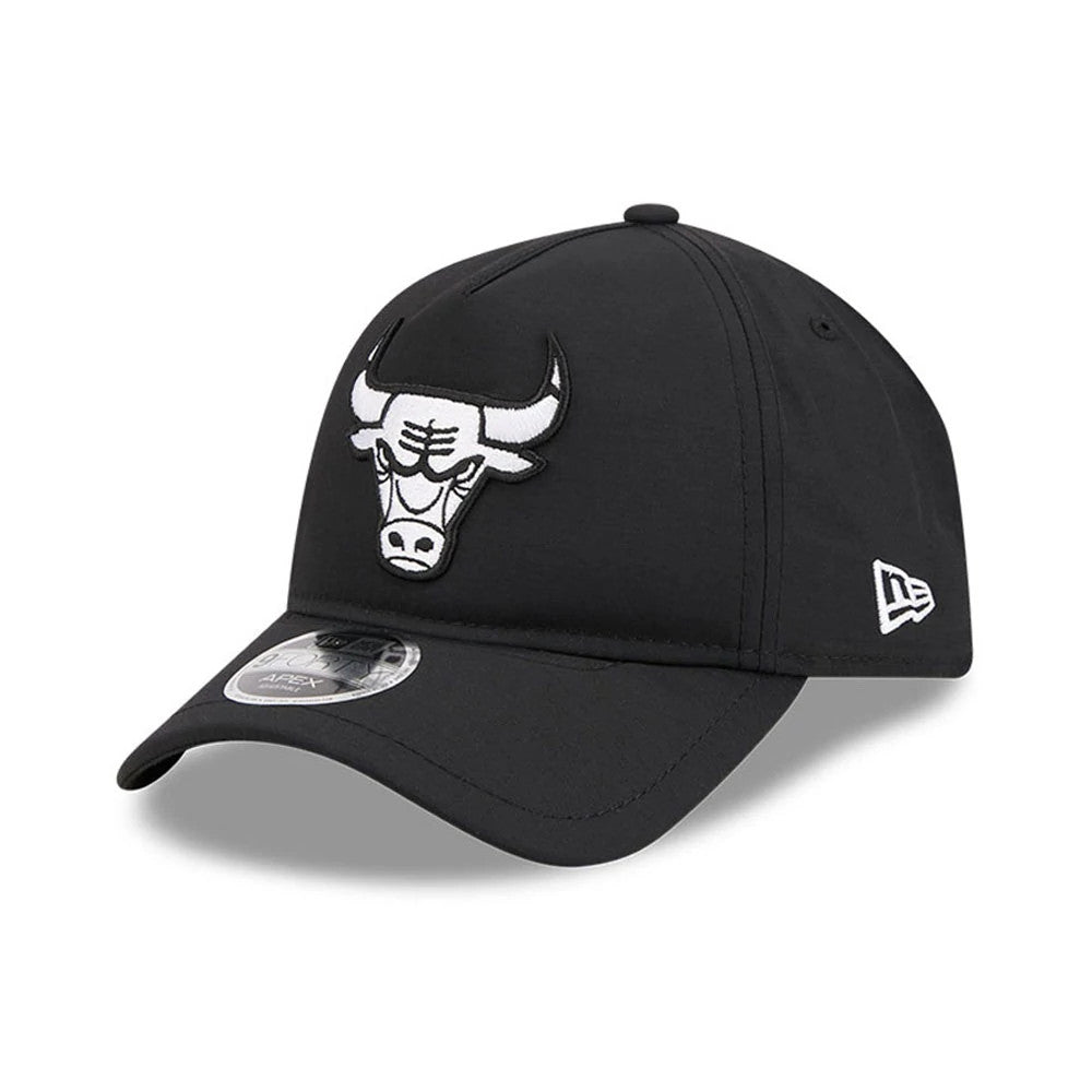 Bulls NBA Quickstrike Black New Era 9FORTY Apex Adjustable Cap, three-quarter view showing the raised embroidered white Bulls logo on the front panel, black curved visor with a 9FORTY size sticker, and the New Era flag logo on the left side.