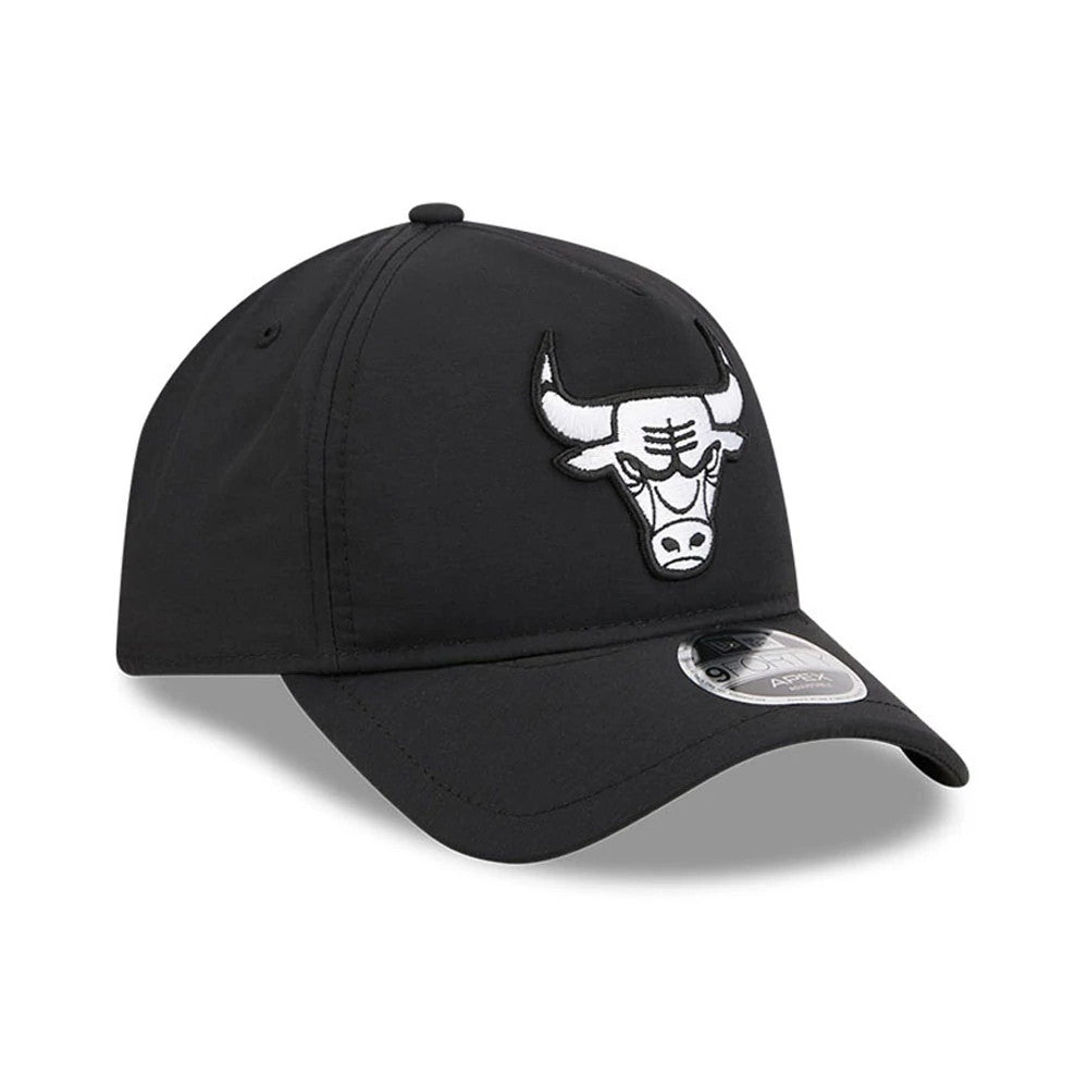 Bulls NBA Quickstrike Black New Era 9FORTY Apex Adjustable Cap, three-quarter view showing a raised embroidered white and black bull logo on the front panel, paired with a curved black visor and a 9FORTY size sticker.