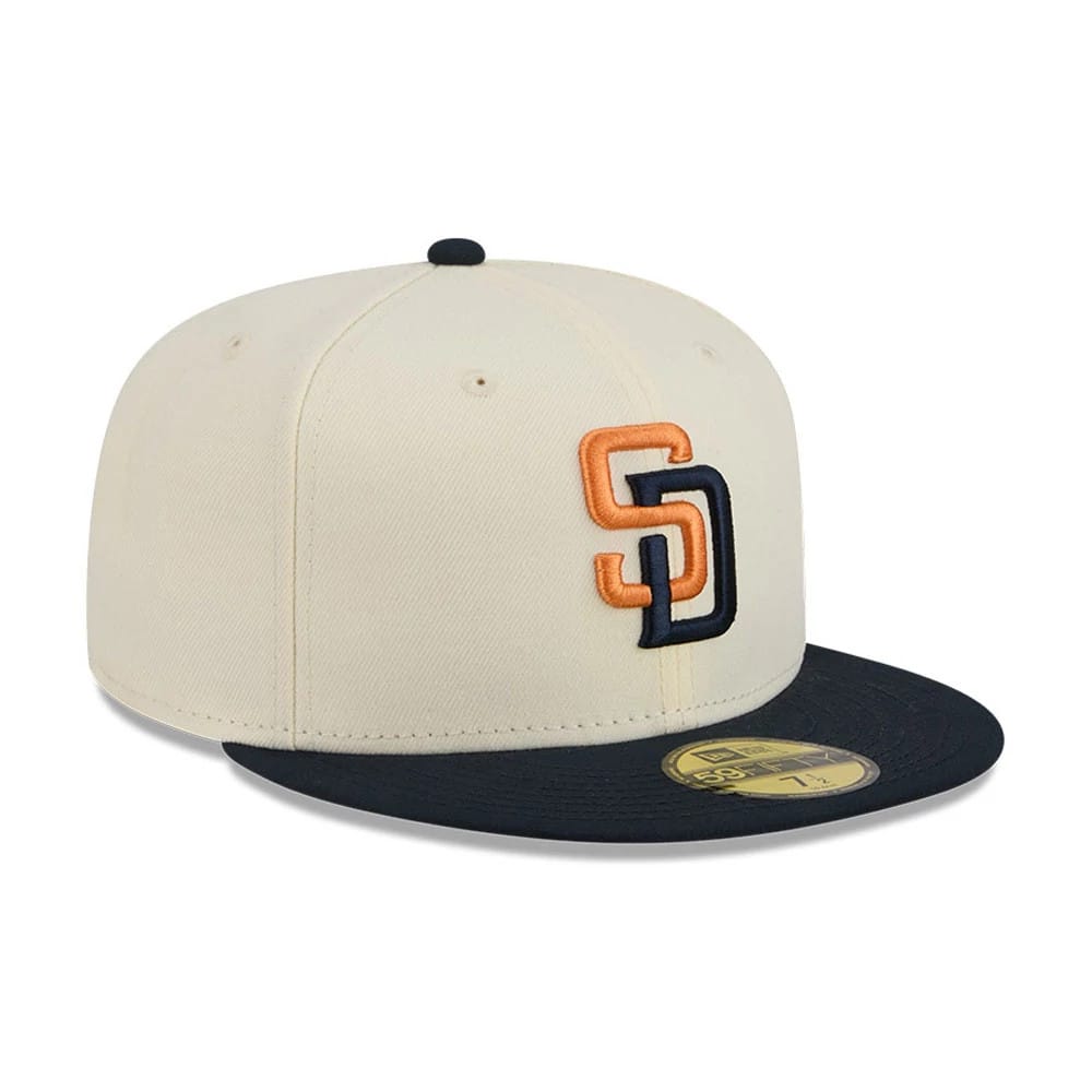 San Diego Padres MLB City Connect Cream New Era 59FIFTY Fitted Cap, three-quarter view showing raised orange and navy SD front logo, black flat visor with gold 59FIFTY size sticker, and black top button.