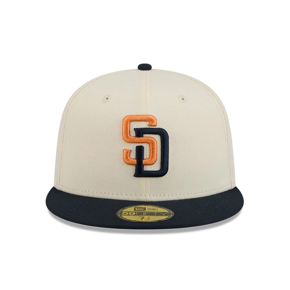 San Diego Padres MLB City Connect Cream New Era 59FIFTY Fitted Cap, front view showing a raised embroidered SD logo in orange and navy on the structured cream front panel, contrasted by a navy visor with a gold 59FIFTY size sticker.