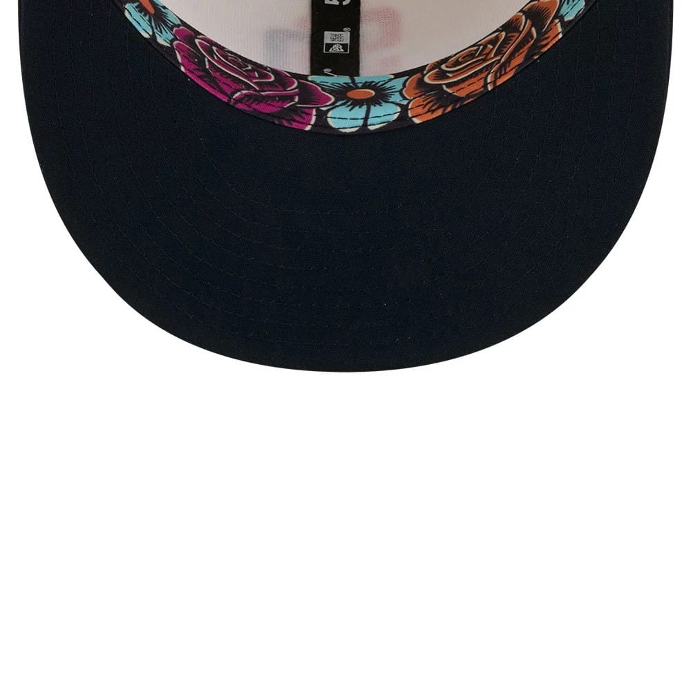 San Diego Padres MLB City Connect Cream New Era 59FIFTY Fitted Cap, inside view showing the black sweatband, NFL and New Era logos on the black taping, and a colourful floral pattern lining the inside of the navy undervisor.