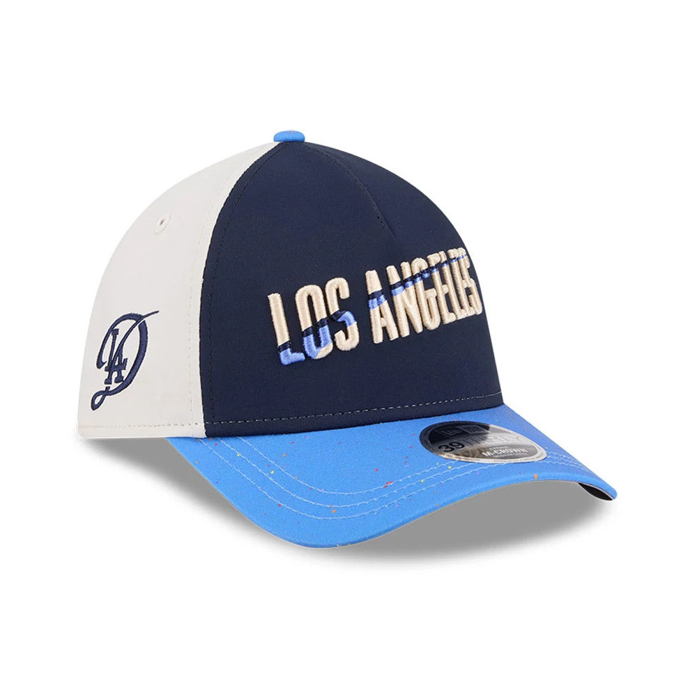 Dodgers MLB City Connect Navy New Era 39THIRTY M-Crown A-Frame Stretch Fit Cap, three-quarter view showing raised embroidered Los Angeles script on the front panel, blue speckled flat visor, and navy LA logo on the white side panel.