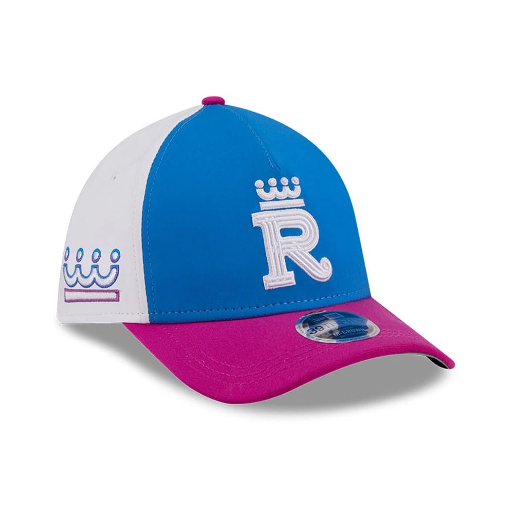 Royals MLB City Connect Blue New Era 39THIRTY M-Crown A-Frame Stretch Fit Cap, three-quarter view showing a raised white R logo with a crown on the blue front panel, a pink curved visor with a 39THIRTY size sticker, and a white left-side crown logo.