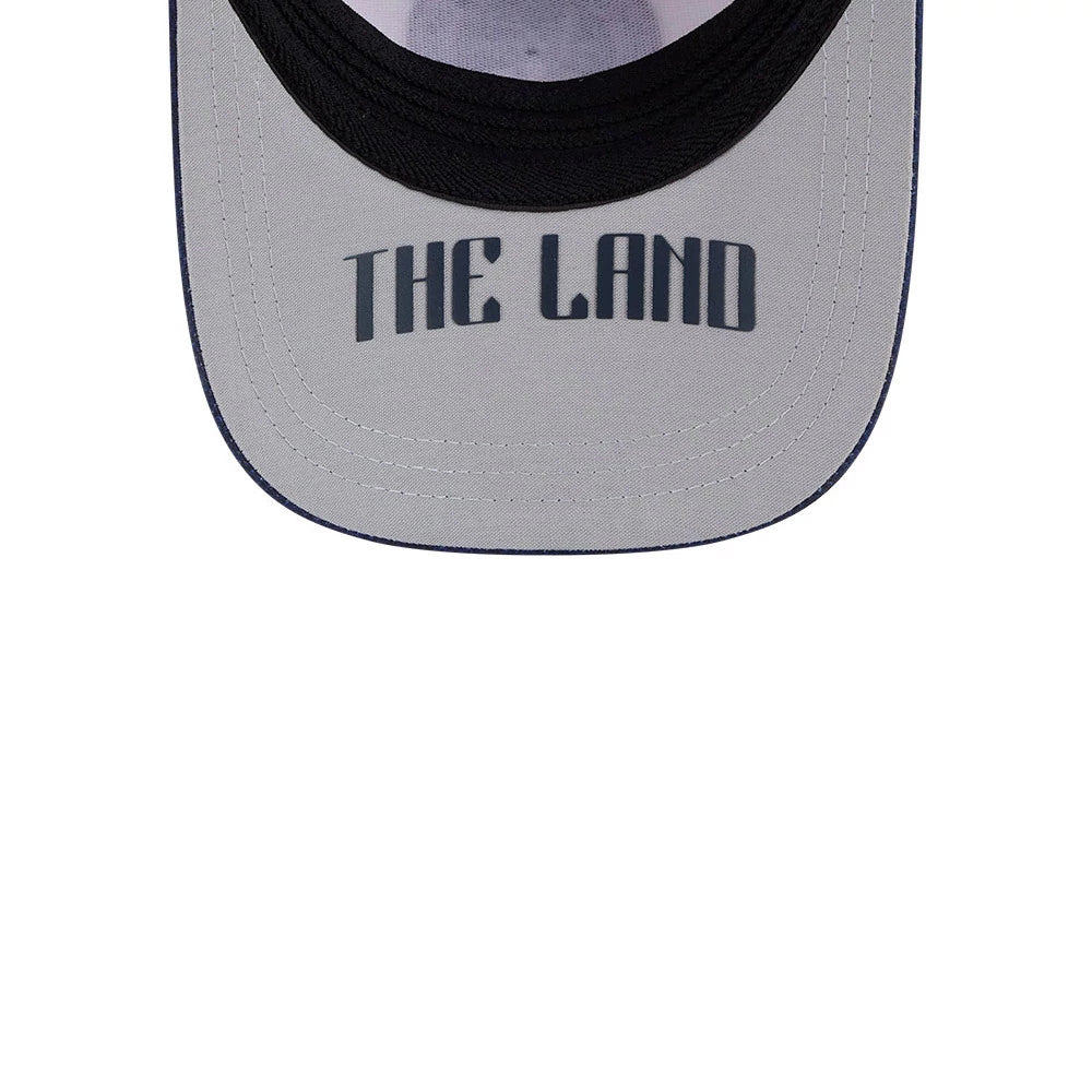 Guardians MLB City Connect White New Era 39THIRTY M-Crown A-Frame Stretch Fit Cap, underside view displaying the grey undervisor with The Land text in black print, featuring a black sweatband and contrasting white internal panel.