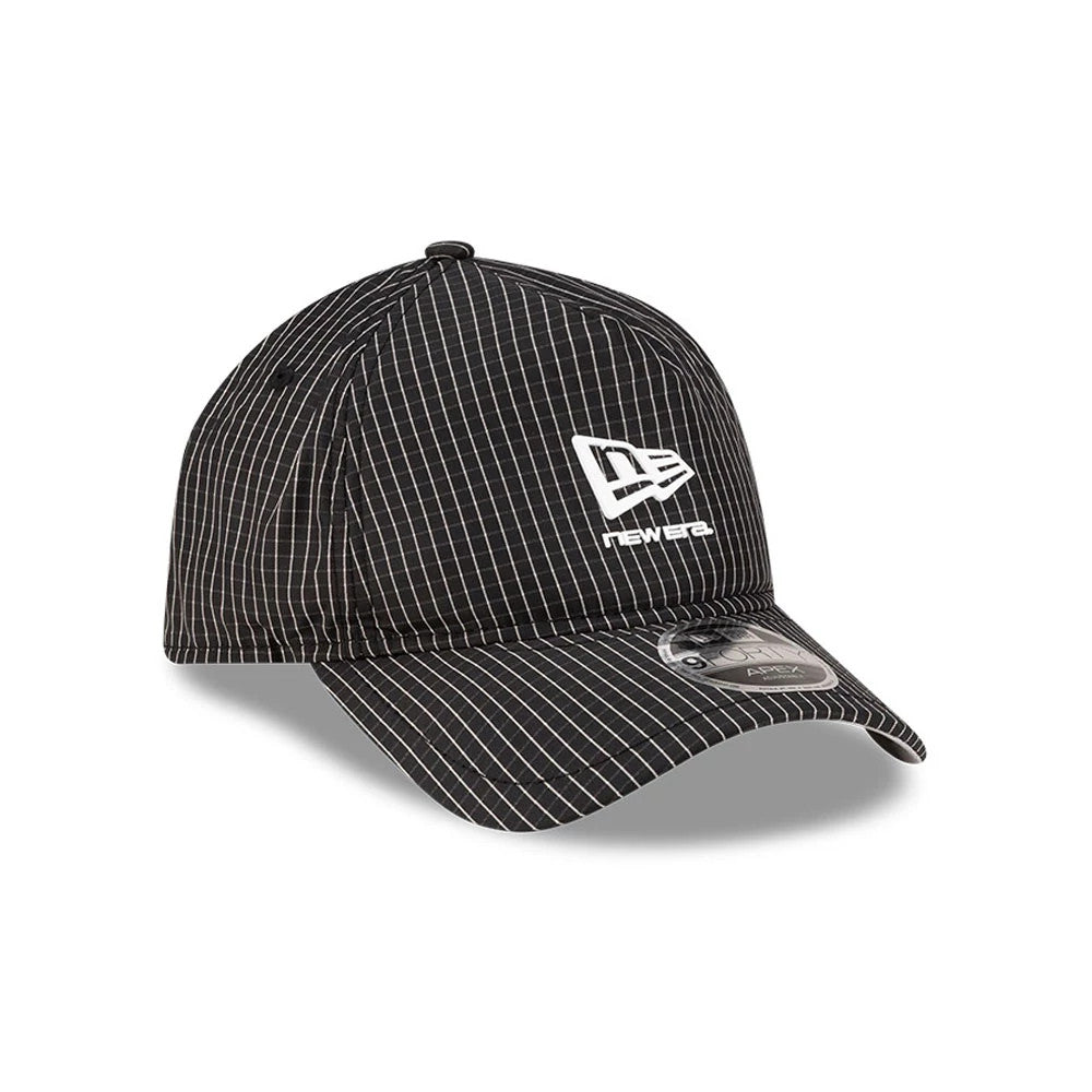 New Era Ripstop Black New Era 9FORTY Apex Cap, three-quarter view showing the white embroidered New Era logo on the front panel, black and white grid pattern on the structured crown and curved visor with a 9FORTY size sticker on top.