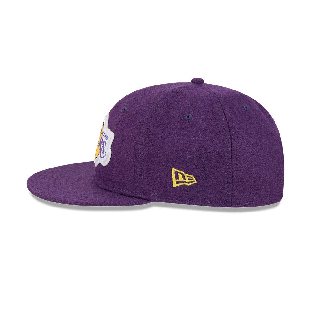 LA Lakers NBA Chenille Woven Purple Retro Crown New Era 9FIFTY Adjustable Cap, side view showing a yellow embroidered New Era flag logo on the left side, structured purple crown with eyelets, and a flat purple visor.