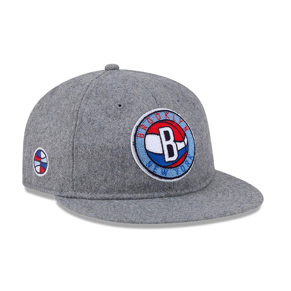 Brooklyn Nets NBA Chenille Woven Grey Retro Crown New Era 9FIFTY Adjustable Cap, three-quarter view showing the large circular Brooklyn Nets logo embroidered on the front panel, with a grey flat visor and a round logo on the left side.