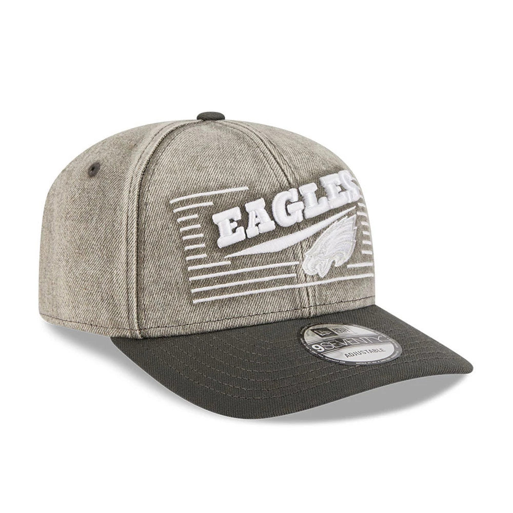 Philadelphia Eagles NFL Washed Denim Dark Grey New Era 9SEVENTY Stretch Snap Cap, three-quarter view showing the raised white Eagles logo embroidery on the front panel with striped detail, curved dark grey visor, and 9SEVENTY size sticker on the top.