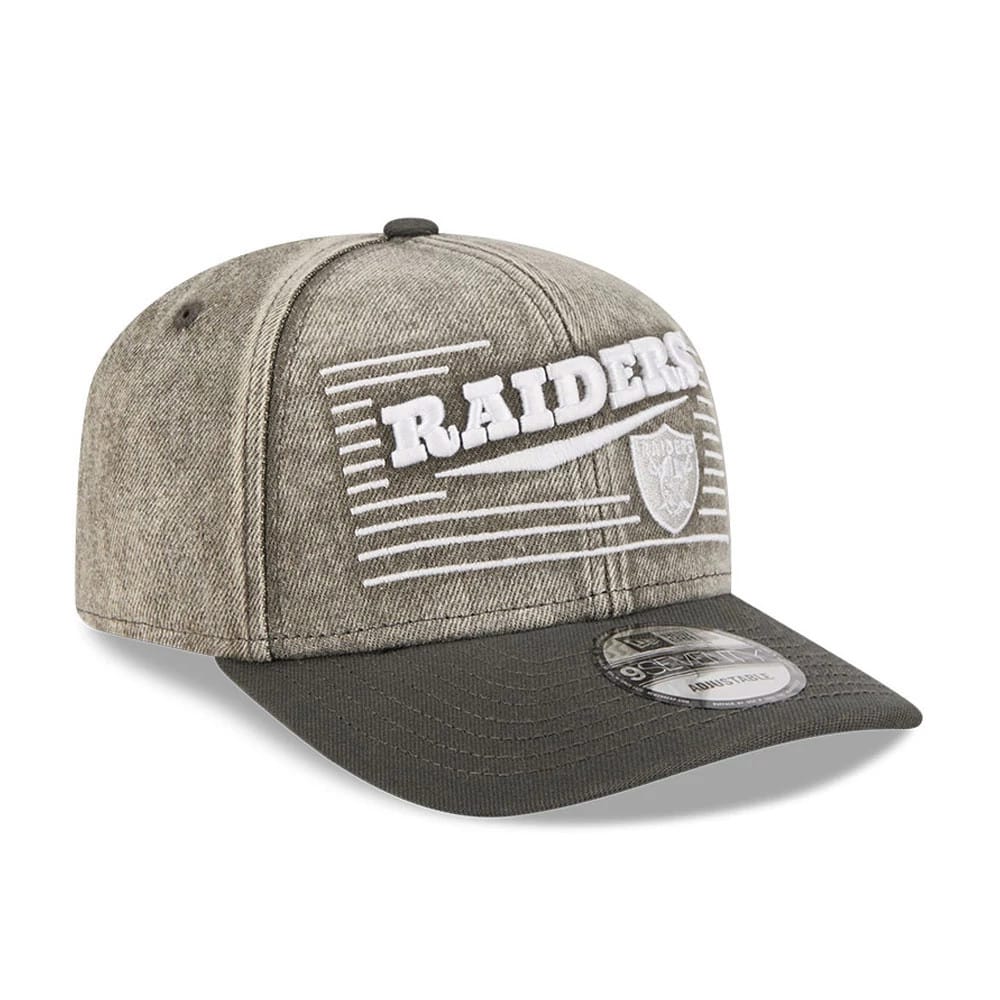Las Vegas Raiders NFL Washed Denim Dark Grey New Era 9SEVENTY Stretch Snap Cap, front view showing the raised white embroidered Raiders logo with horizontal lines on the dark grey crown and a dark grey visor with the 9SEVENTY size sticker.