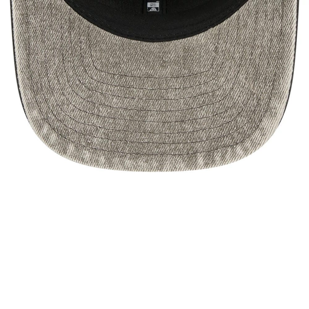 Las Vegas Raiders NFL Washed Denim Dark Grey New Era 9SEVENTY Stretch Snap Cap, inside view showing the washed denim dark grey undervisor with stitching, a black sweatband and the New Era taping across the interior.