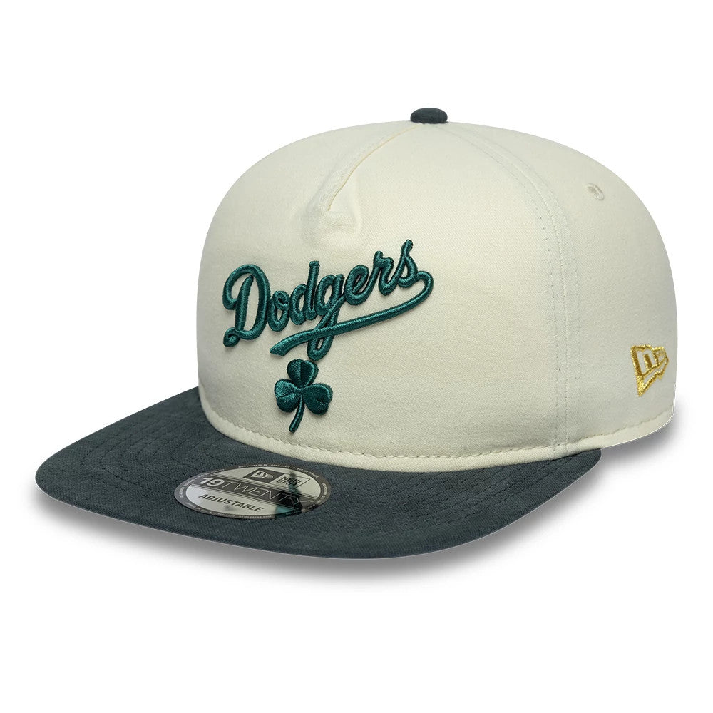 LA Dodgers MLB Metallic Logo Cream New Era 19TWENTY Adjustable Cap, front view showing the raised green Dodgers script logo with a shamrock on the cream crown, dark grey flat visor with 19TWENTY size sticker, and gold New Era flag on the left side.