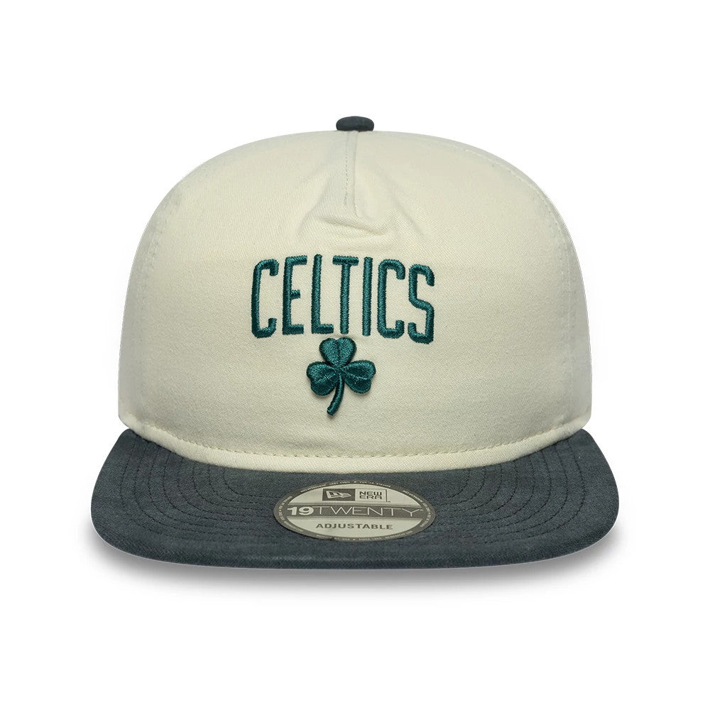 Boston Celtics NBA Metallic Logo Cream New Era 19TWENTY Adjustable Cap, front view showing the raised green Celtics lettering and shamrock embroidery on the structured cream crown, with a flat grey visor and 19TWENTY size sticker on top.