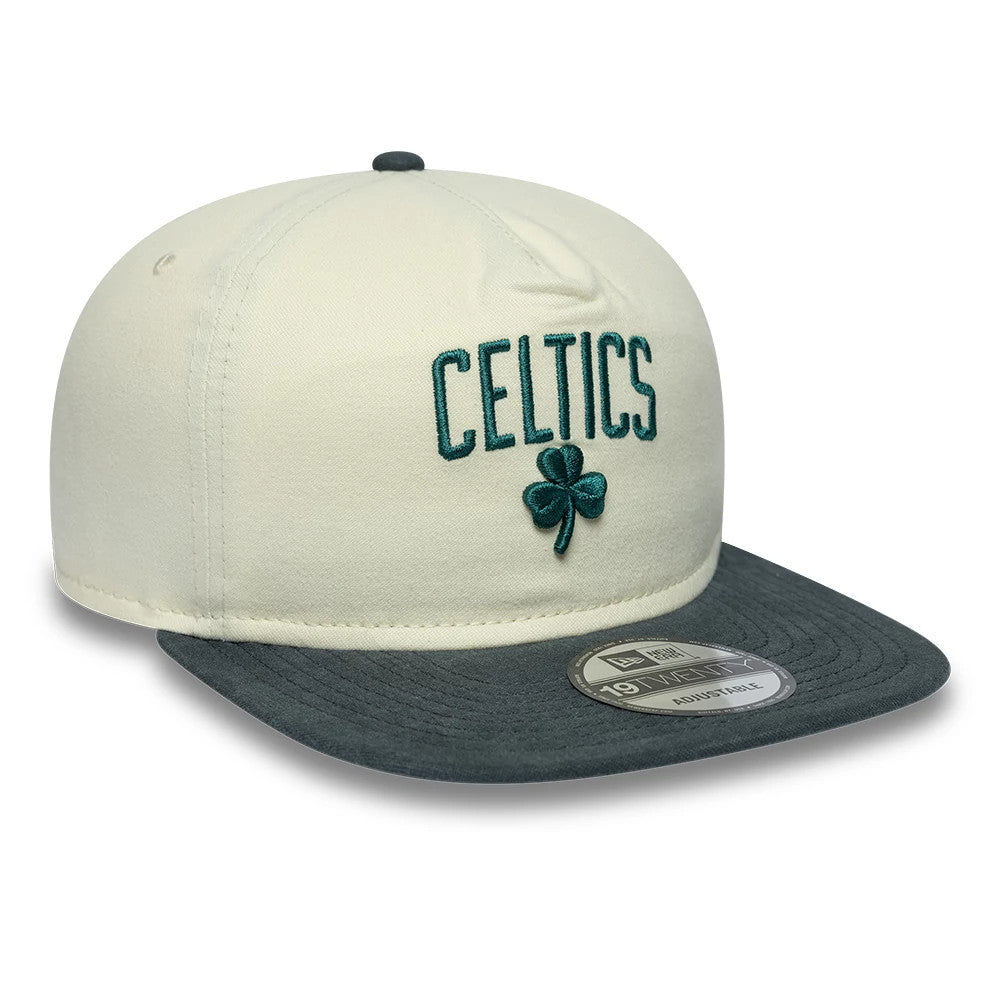 Boston Celtics NBA Metallic Logo Cream New Era 19TWENTY Adjustable Cap, three-quarter view showing the green embroidered Celtics lettering and clover on the front panel, a contrasting grey visor, and a 19TWENTY size sticker on the top of the visor.