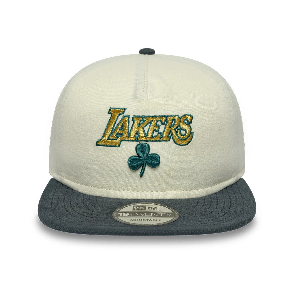 LA Lakers NBA Metallic Logo Cream New Era 19TWENTY Adjustable Cap, front view showing the gold and green embroidered Lakers logo with a shamrock on the cream front panel, complemented by a grey visor with the 19TWENTY size sticker.