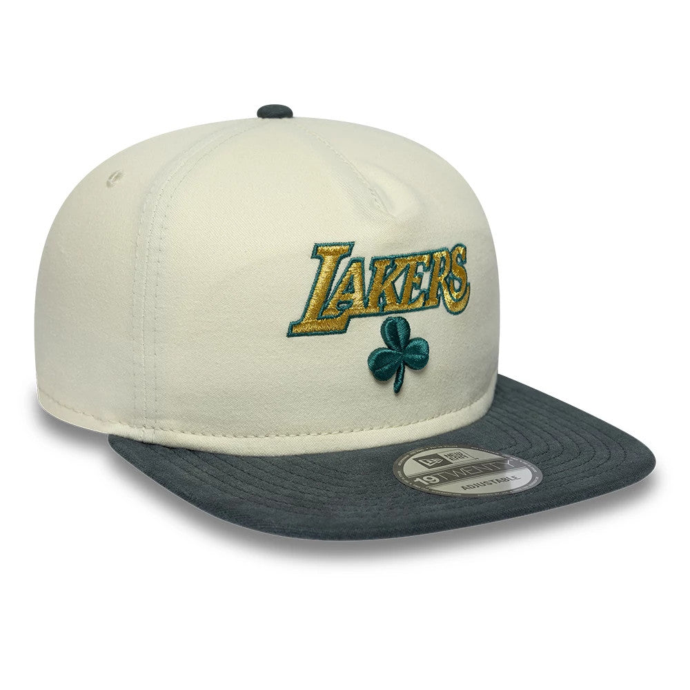 LA Lakers NBA Metallic Logo Cream New Era 19TWENTY Adjustable Cap, three-quarter view showing the gold and green embroidered Lakers logo and clover on the cream front panel, with a contrasting grey visor and a 19TWENTY size sticker.