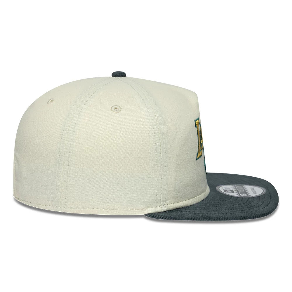 LA Lakers NBA Metallic Logo Cream New Era 19TWENTY Adjustable Cap, side view showing the gold and blue embroidered LA logo on the cream panel, a black top button, and a grey flat visor with a 19TWENTY size sticker.