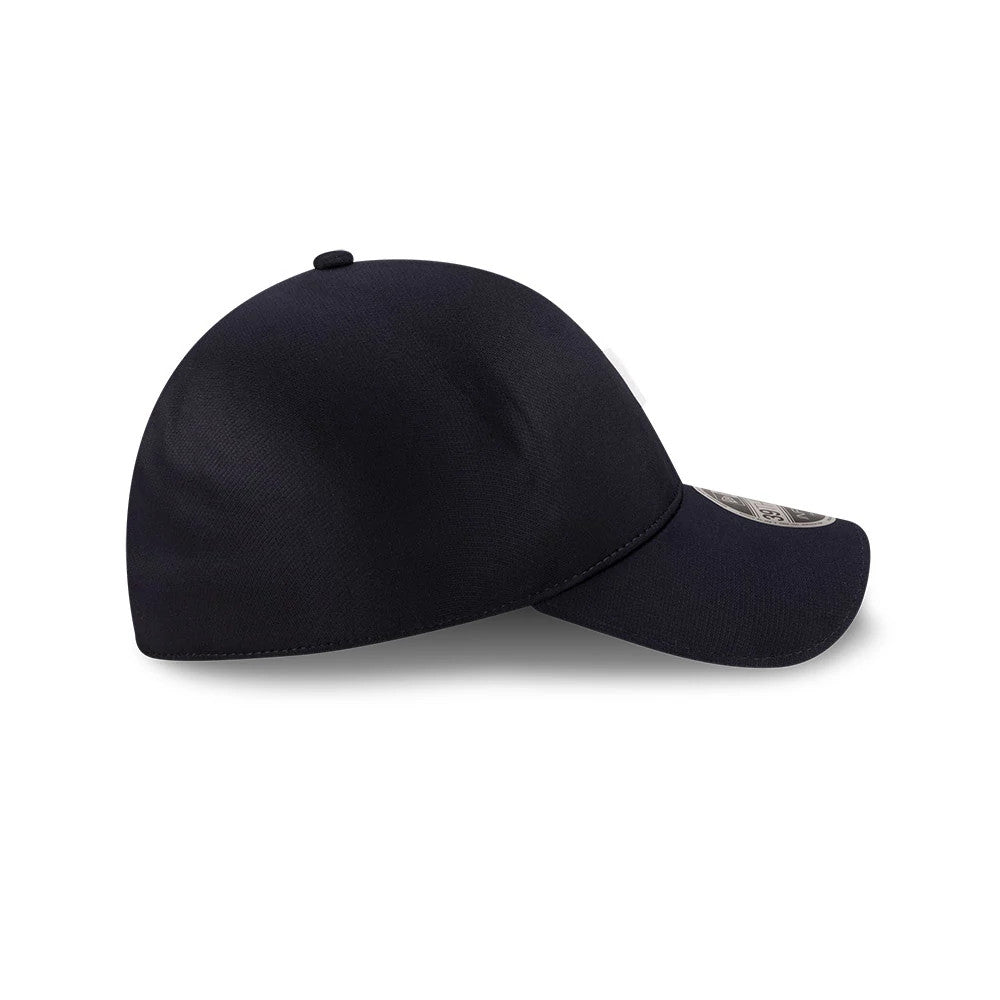 New Era Navy 39THIRTY Infinity Stretch Fit Cap, side view showing a navy crown with a matching curved visor, the New Era flag logo embroidered in white on the left side, and a 39THIRTY size sticker on the visor.
