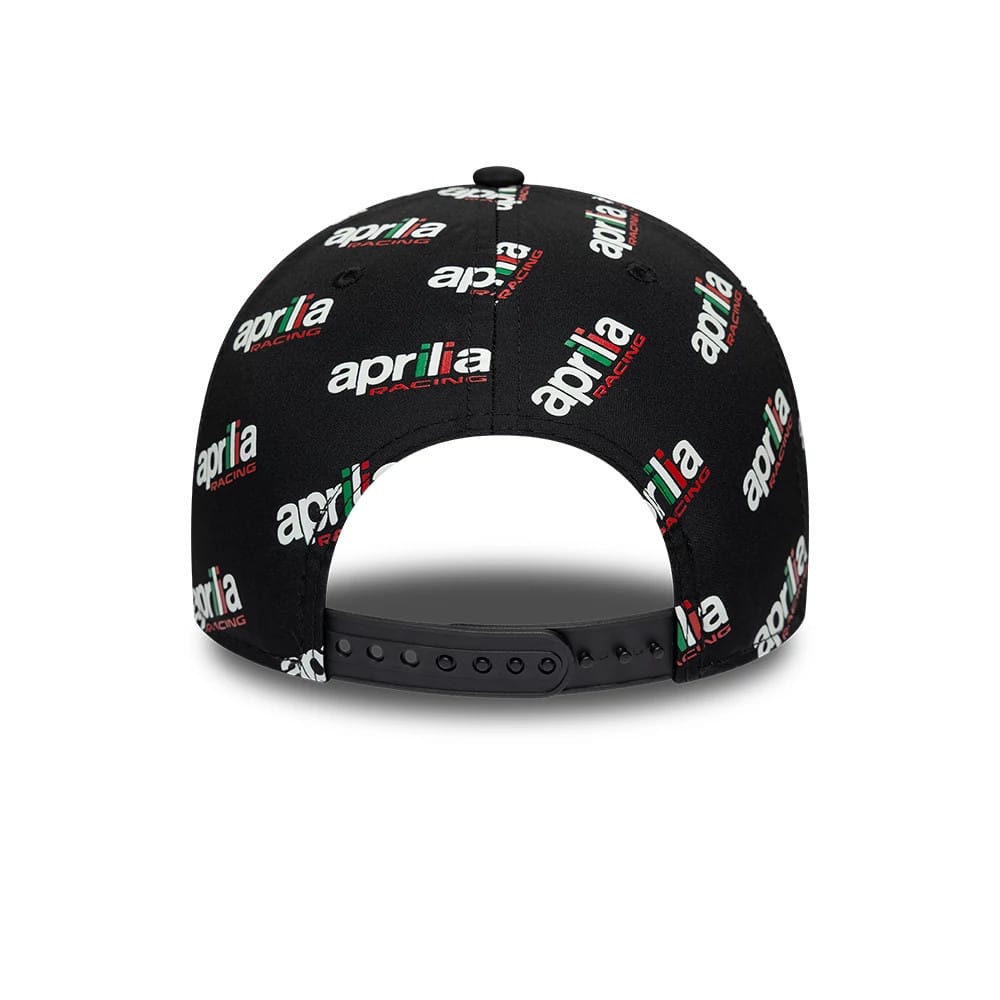 Aprilia All Over Print Black New Era 9FORTY Adjustable Cap, rear view showing multiple Aprilia Racing logos in white, red, and green printed across the black structured crown, with a black adjustable strap at the back.