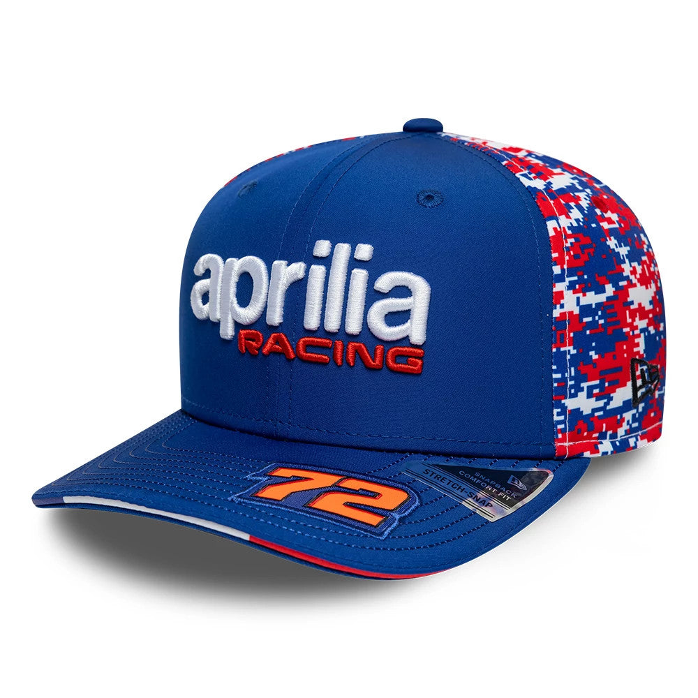 Aprilia Replica Marco Bezzecchi Le Mans Race Special Blue New Era 9SEVENTY Stretch Snap Adjustable Cap, front view showing white and red aprilia Racing logo in raised embroidery on the structured blue crown, with number 72 on the visor.
