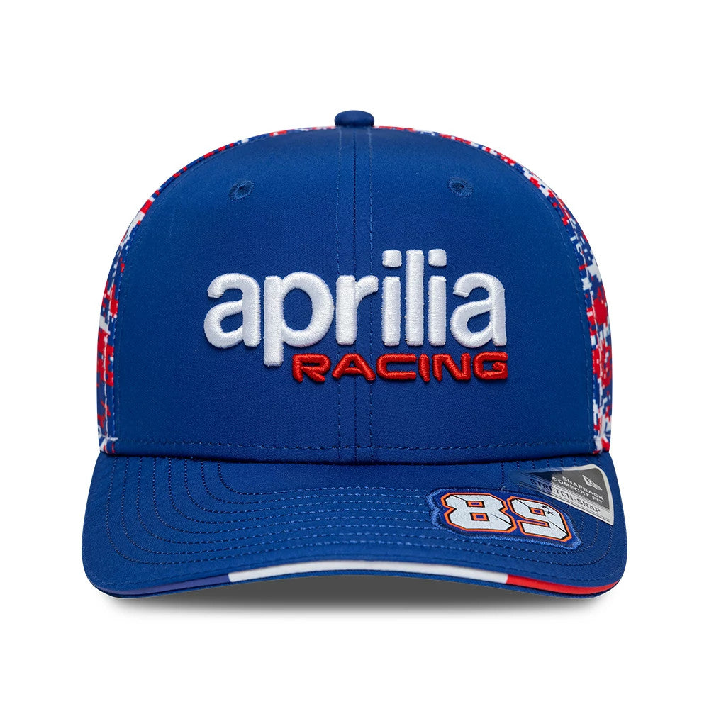 Aprilia Replica Jorge Martin Le Mans Race Special Blue New Era 9SEVENTY Stretch Snap Adjustable Cap, front view showing white and red embroidered aprilia racing logo, blue curved visor with '89' applique on the right, and a 9SEVENTY size sticker.