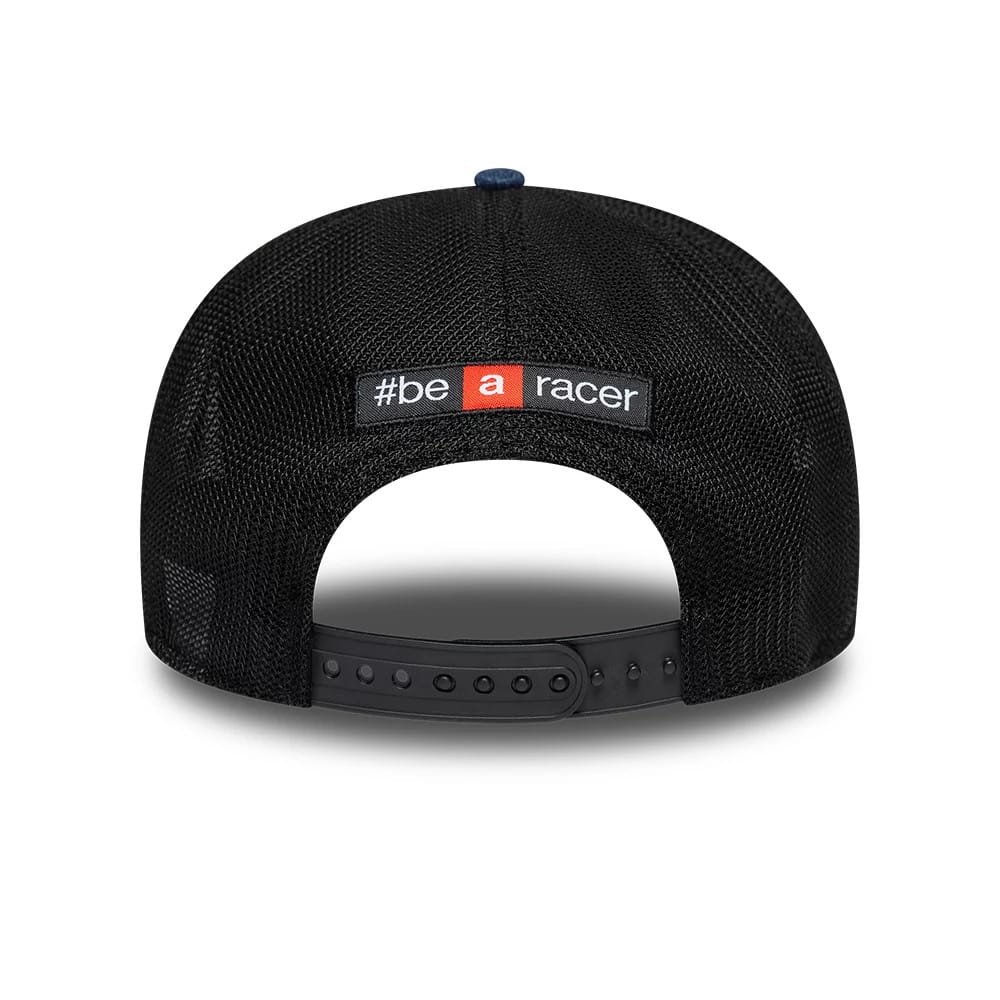 Aprilia Replica Austin Race Special Blue New Era 9SEVENTY Stretch Snap Adjustable Cap, rear view showing the '#be a racer' slogan embroidered in white and red on a black patch, above the black adjustable snap closure on the mesh cap.