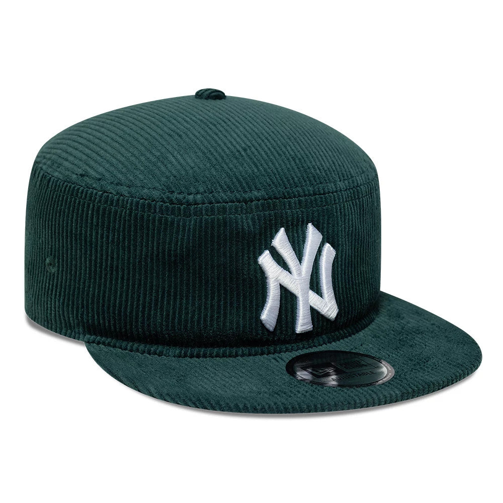 New Era New York Yankees MLB Cord Dark Green Pillbox Adjustable Cap, three-quarter view showing the raised white NY logo embroidered on the front panel, featuring a unique corduroy texture and a flat dark green visor with a New Era size sticker.