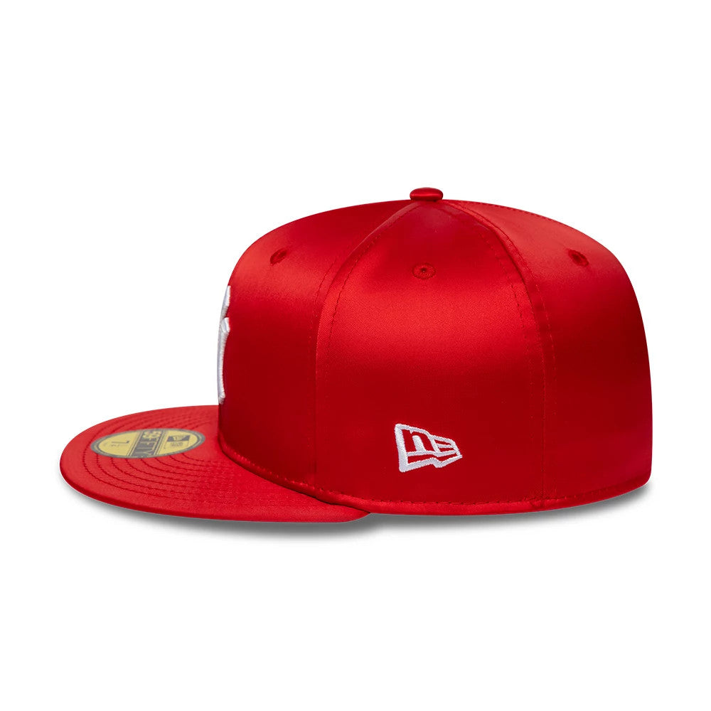 New York Yankees MLB Satin Red New Era 59FIFTY Fitted Cap, side view showing the white New Era flag logo embroidered on the left side of the satin red crown, with eyelets and a 59FIFTY size sticker on the flat red visor.