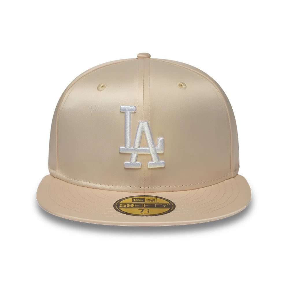 LA Dodgers MLB Satin Cream New Era 59FIFTY Fitted Cap, front view showing the raised white embroidered LA logo on the structured cream satin crown, with a matching cream visor and gold 59FIFTY size sticker on the visor.