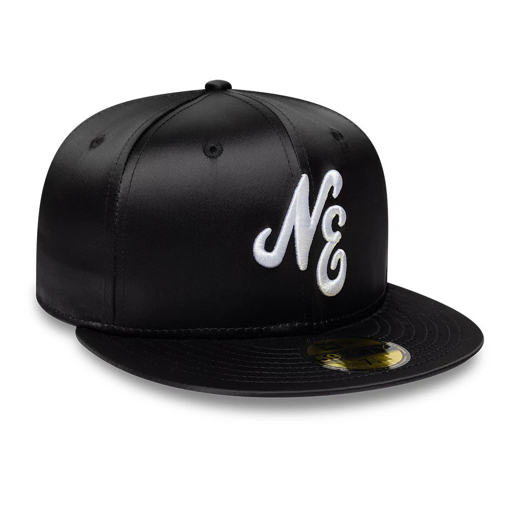 New Era Satin Black 59FIFTY Fitted Cap, front view showing white raised embroidered script initials on the front panel, with a satin finish and a gold 59FIFTY size sticker on the flat black visor.