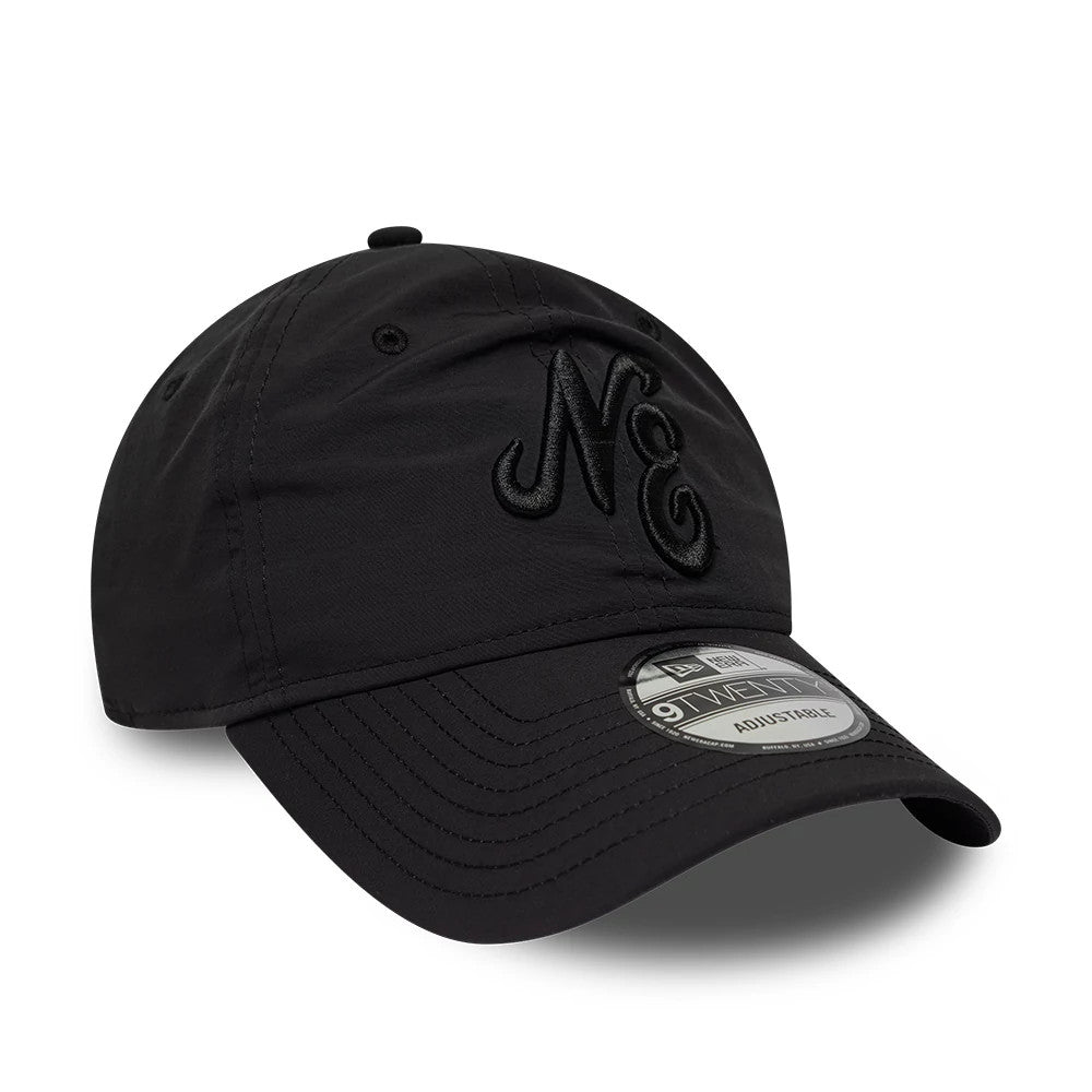 New Era Recycled Black On Black 9TWENTY Adjustable Cap, three-quarter view showing the black embroidered NE lettering on the front panel, curved black visor, and 9TWENTY size sticker on the top.