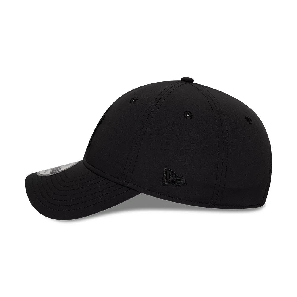 New York Yankees MLB Recycled Black On Black New Era 9TWENTY Adjustable Cap, side view showing the embroidered New Era flag logo on the left side of the unstructured, low-profile black crown, finished with a curved visor and size sticker.