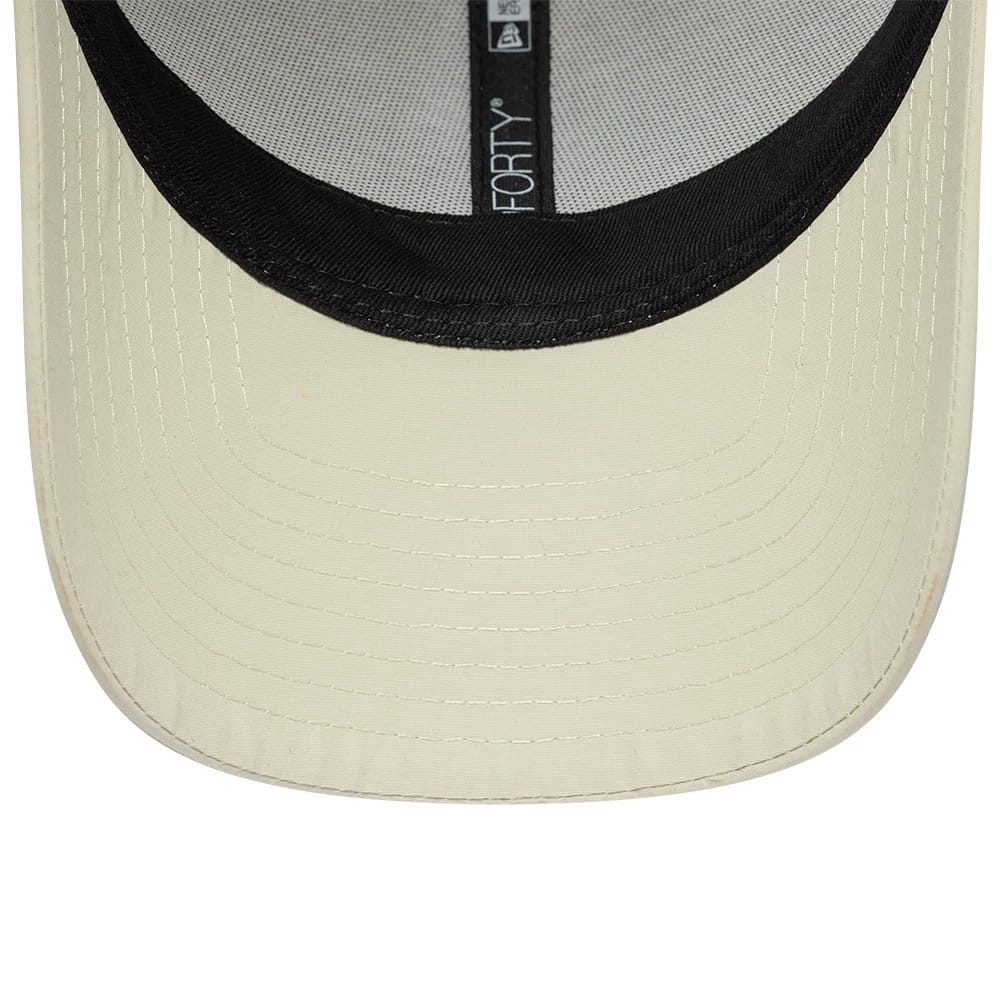 New Era Mini Logo Recycled Light Beige 9FORTY Adjustable Cap, inside view showing the black sweatband lining along the edge of the light beige visor and distinct black taping with 9FORTY branding along the crown's interior.