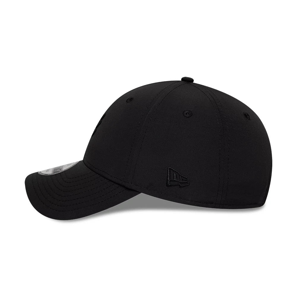 New Era Mini Logo Recycled Black On Black 9FORTY Adjustable Cap, side view showing the black embroidered New Era flag logo on the left side, with a curved black visor and a black 9FORTY size sticker on top of the visor.