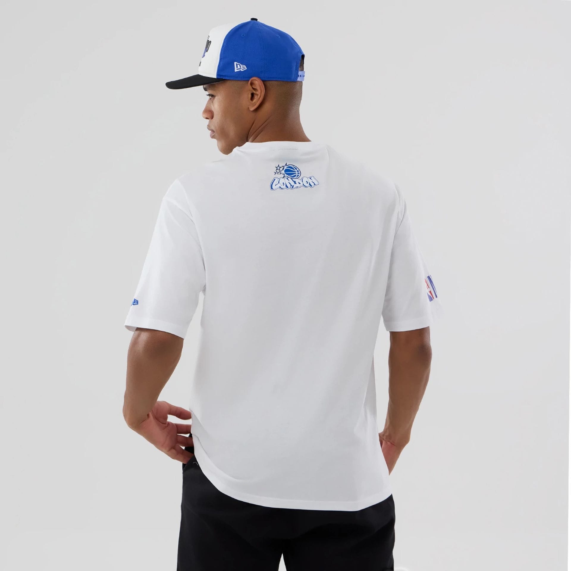 The model is wearing this NBA London Game 2026 Orlando Magic Oversized T-Shirt in white. 2