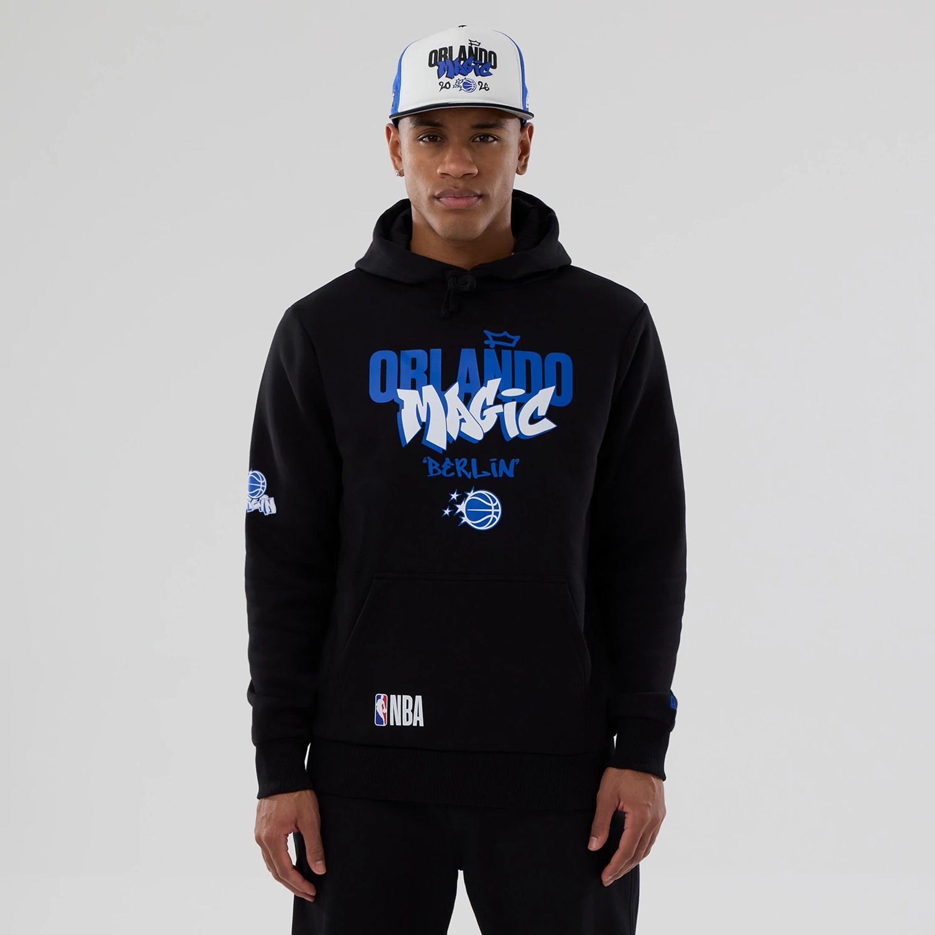 The model is wearing this NBA Berlin Game 2026 Orlando Magic Pullover Hoodie in black. 1