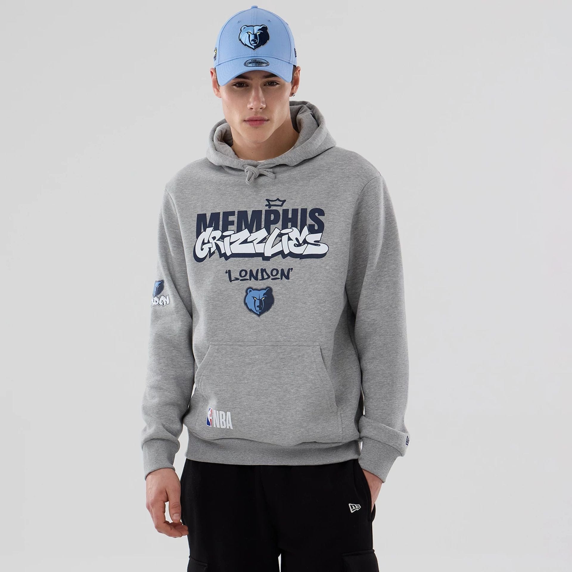 The model is wearing this NBA London Game 2026 Memphis Grizzlies Pullover Hoodie in grey. 1