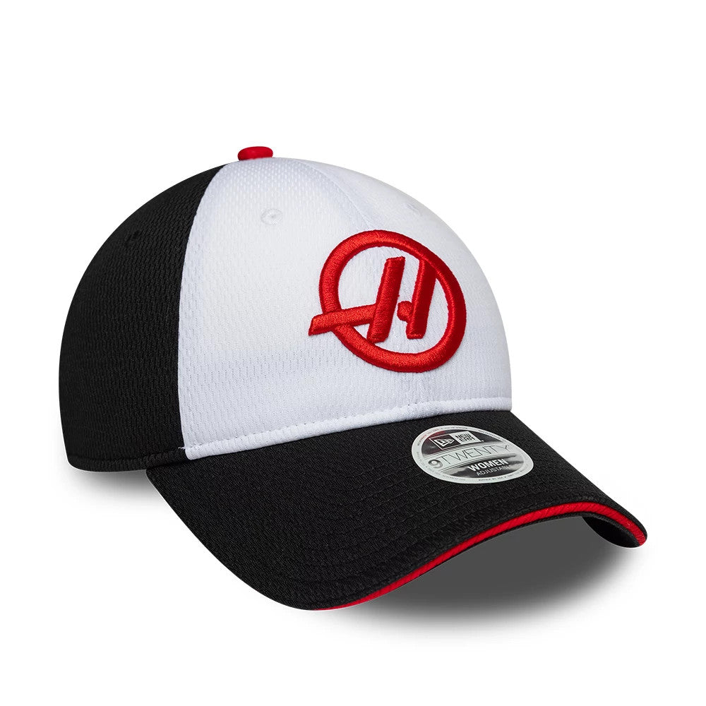 New Era TGR Haas F1 Womens Black Open Back Cap, three-quarter view showing the red embroidered Haas logo on the white front panel, black curved visor with red edge trim, and a 9FORTY size sticker on the top of the visor.