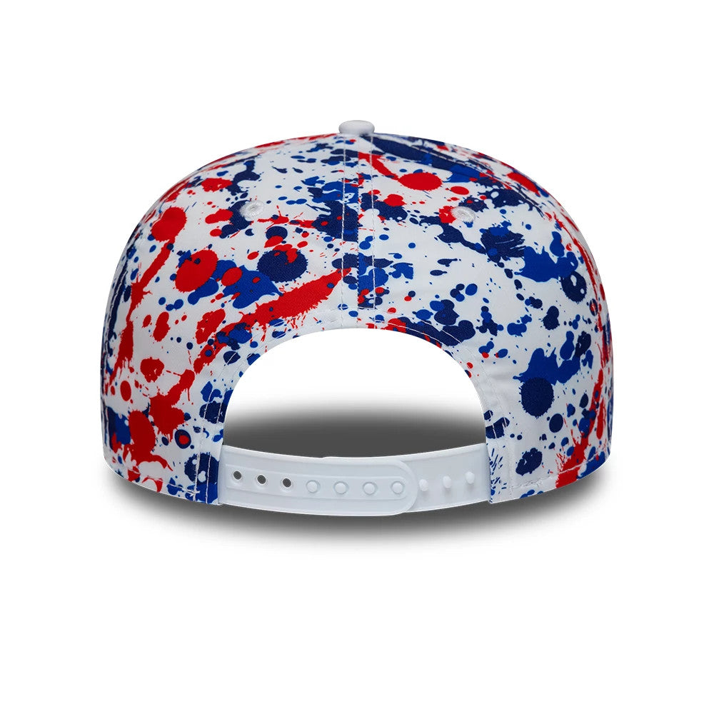 TGR Haas F1 Team Silverstone Race Special White New Era 9SEVENTY Stretch Snap Cap, rear view featuring a unique red and blue splatter pattern on the white panels, with a white adjustable snapback closure and a matching top button.