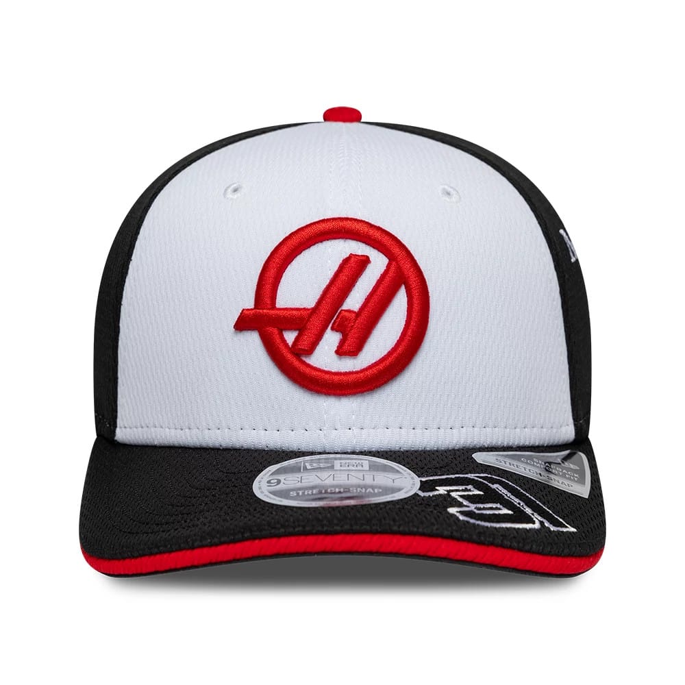 TGR Haas F1 Esteban Ocon Black New Era 9SEVENTY Stretch Snap Adjustable Cap, front view showing the red embroidered TGR Haas logo on a white front panel, black visor with contrasting red edging, and the 9SEVENTY size sticker on the visor.