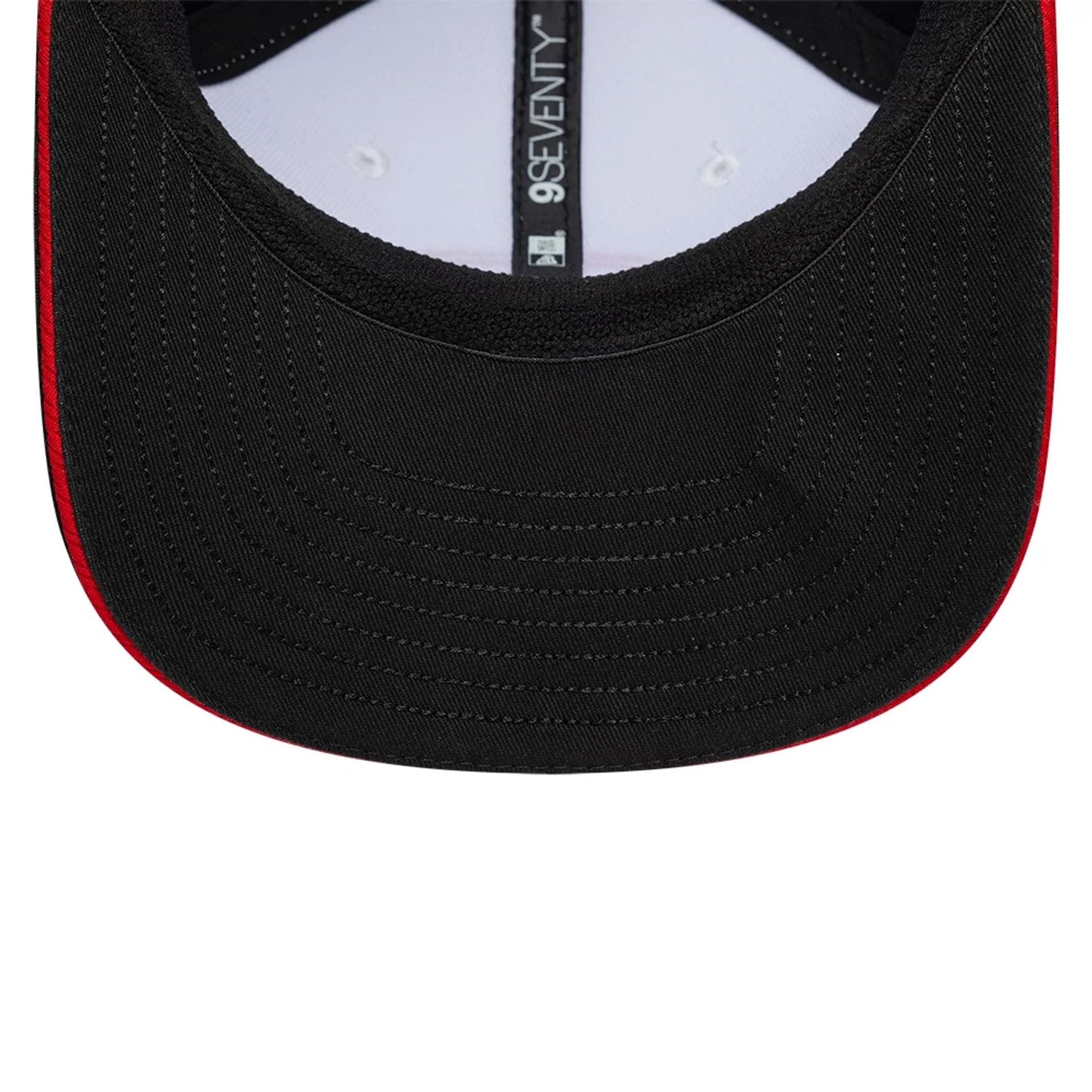 TGR Haas F1 Esteban Ocon Black New Era 9SEVENTY Stretch Snap Adjustable Cap, inside view showing the black undervisor with a red edge, white sweatband, and black taping with the 9SEVENTY logo running down the centre.
