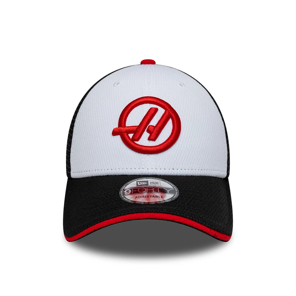 TGR Haas F1 Summer League Black New Era 9FORTY Adjustable Cap, front view showing a red circular Haas logo embroidered on the white front panel, black curved visor with a red trim, and 9FORTY size sticker on the visor.