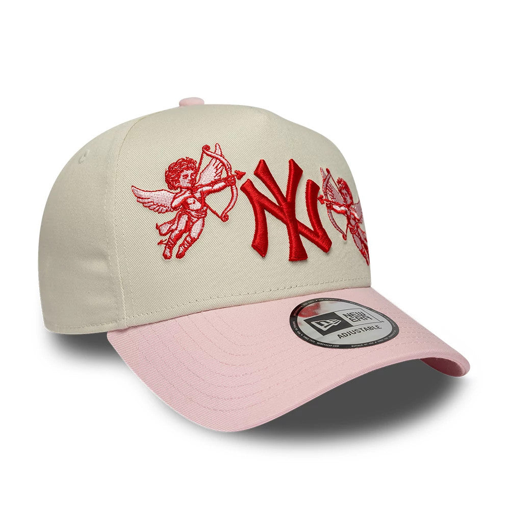 New York Yankees MLB Cherub Cream & Pink New Era 9FORTY A-Frame Adjustable Cap, three-quarter view showing red embroidered cherubs and NY logo on cream front panels, pink curved visor, and 9FORTY size sticker.