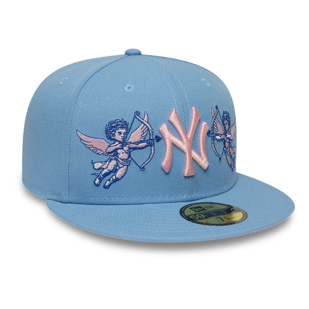 New York Yankees MLB Cherub Pastel Blue New Era 59FIFTY Fitted Cap, front view showing a pink raised embroidered NY logo flanked by blue and pink cherub designs on the front panels, with a gold 59FIFTY size sticker on the flat blue visor.