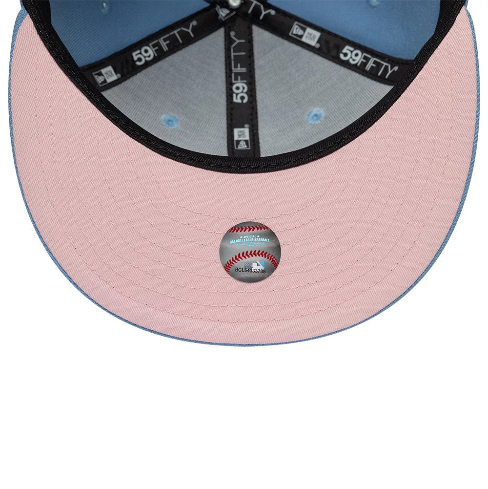 New York Yankees MLB Cherub Pastel Blue New Era 59FIFTY Fitted Cap, inside view showing the pink undervisor with a round MLB sticker at the centre, blue taping with white logos, and a contrasting light blue fabric under the crown.