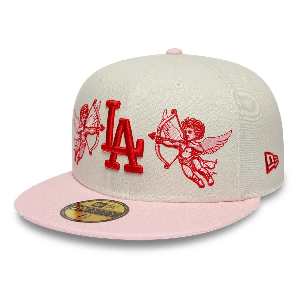LA Dodgers MLB Cherub Cream & Pink New Era 59FIFTY Fitted Cap, front view showing raised red LA logo and cherub embroidery on cream panels, complemented by a pink flat visor and 59FIFTY size sticker on the visor's top.