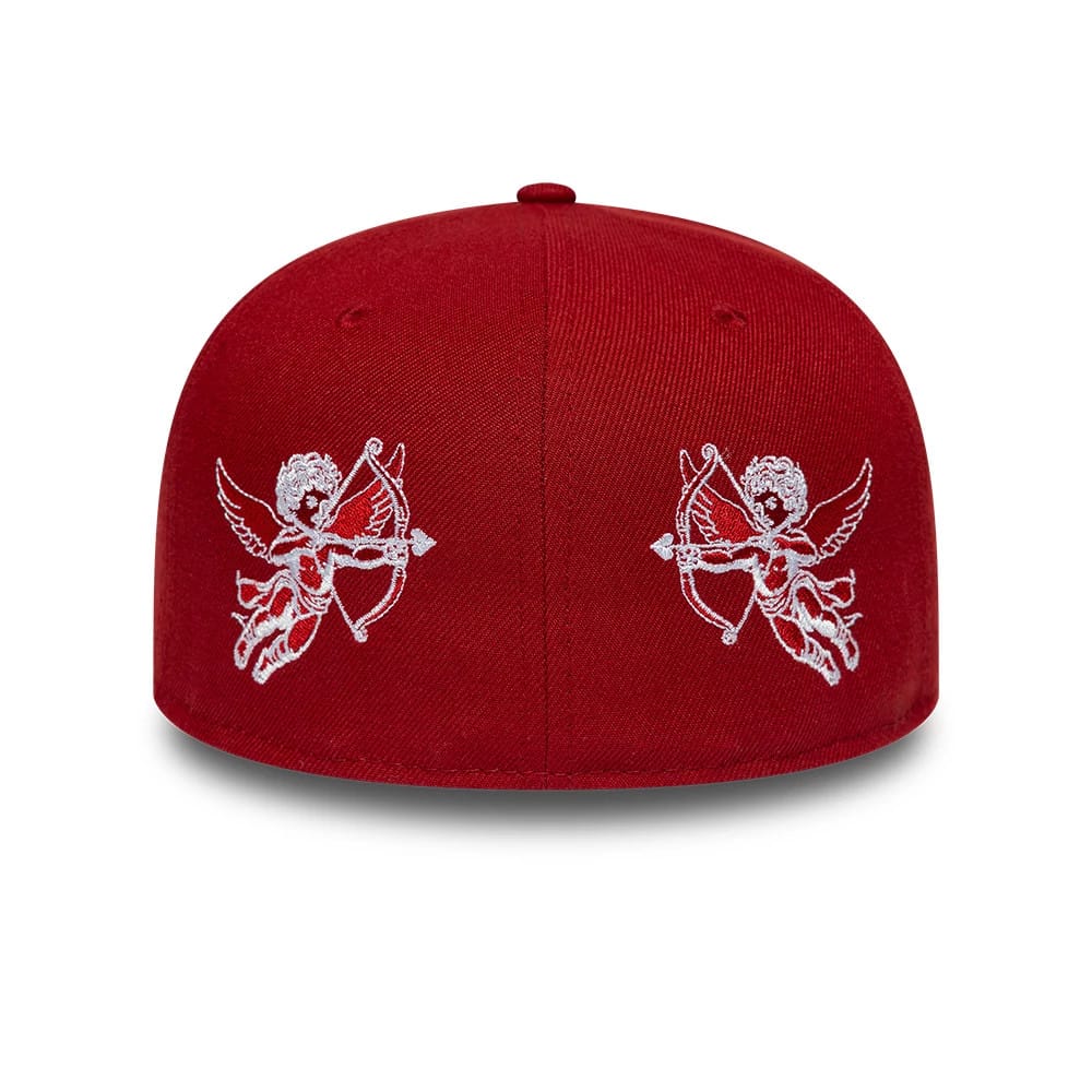 New Era Cherub Dark Red 59FIFTY Fitted Cap, rear view showing two intricately embroidered white cherub graphics holding bows on the red structured crown, with eyelets and a top button enhancing the elegant design.