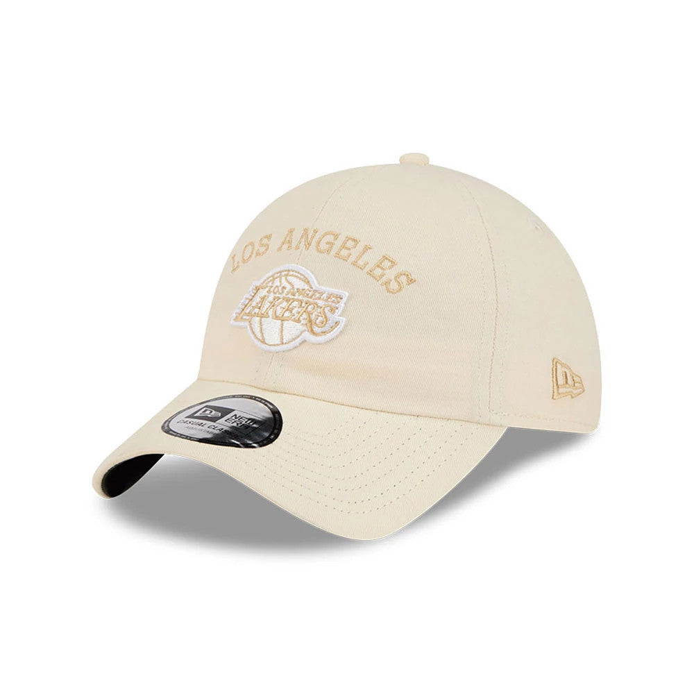 New Era LA Lakers NBA Team Logo White Casual Classic Adjustable Cap, three-quarter view showing the tan embroidered Los Angeles Lakers logo on the front panel, a curved visor with a 9FORTY size sticker, and the New Era flag logo on the left side.