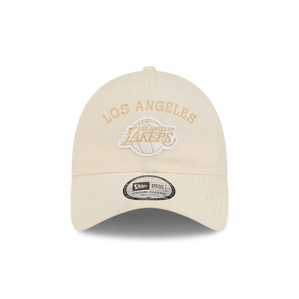 New Era LA Lakers NBA Team Logo White Casual Classic Adjustable Cap, front view showing white raised embroidery of the Los Angeles Lakers logo on the structured white crown, with a curved visor and a New Era Casual Classic size sticker on the visor.